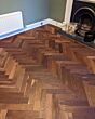 DaLuther Herringbone engineered wood flooring installed in a living room.