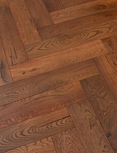 Distressed smoked oak herringbone flooring in 125mm x 600mm board layout.